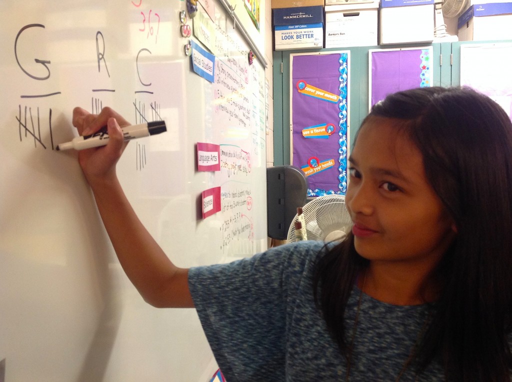 Student writing tally of Waste Audit