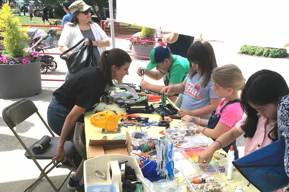 Volunteer repairing electronics at the Repair Cafe event.