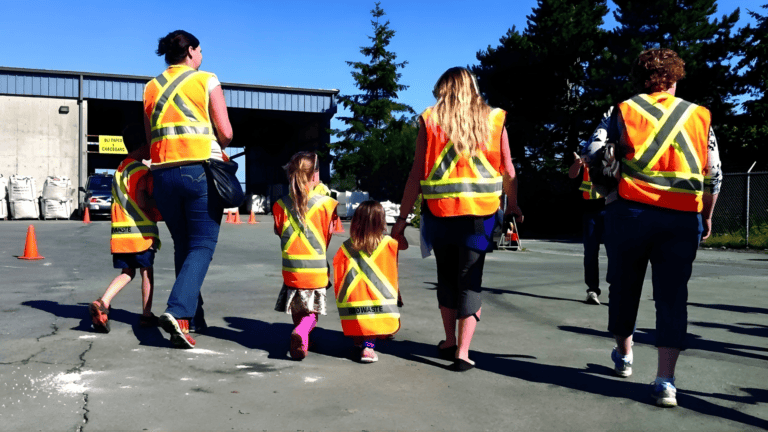 Children and adults participating in an environmental education workshop at Ridge Meadows Recycling.
