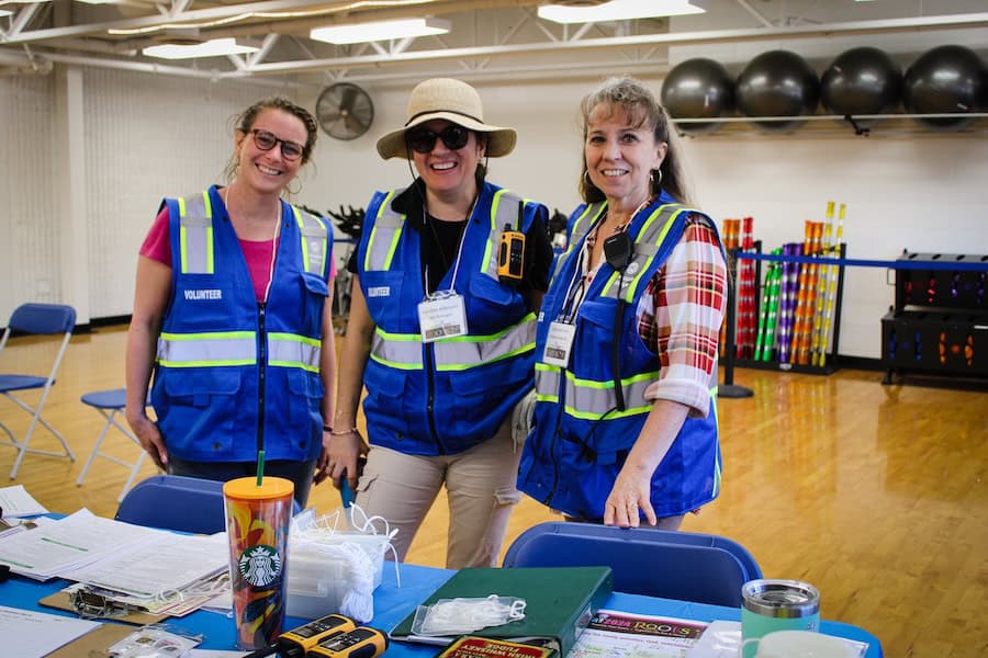 Volunteers from Ridge Meadows Recycling Society wearing safety vests at community recycling event.